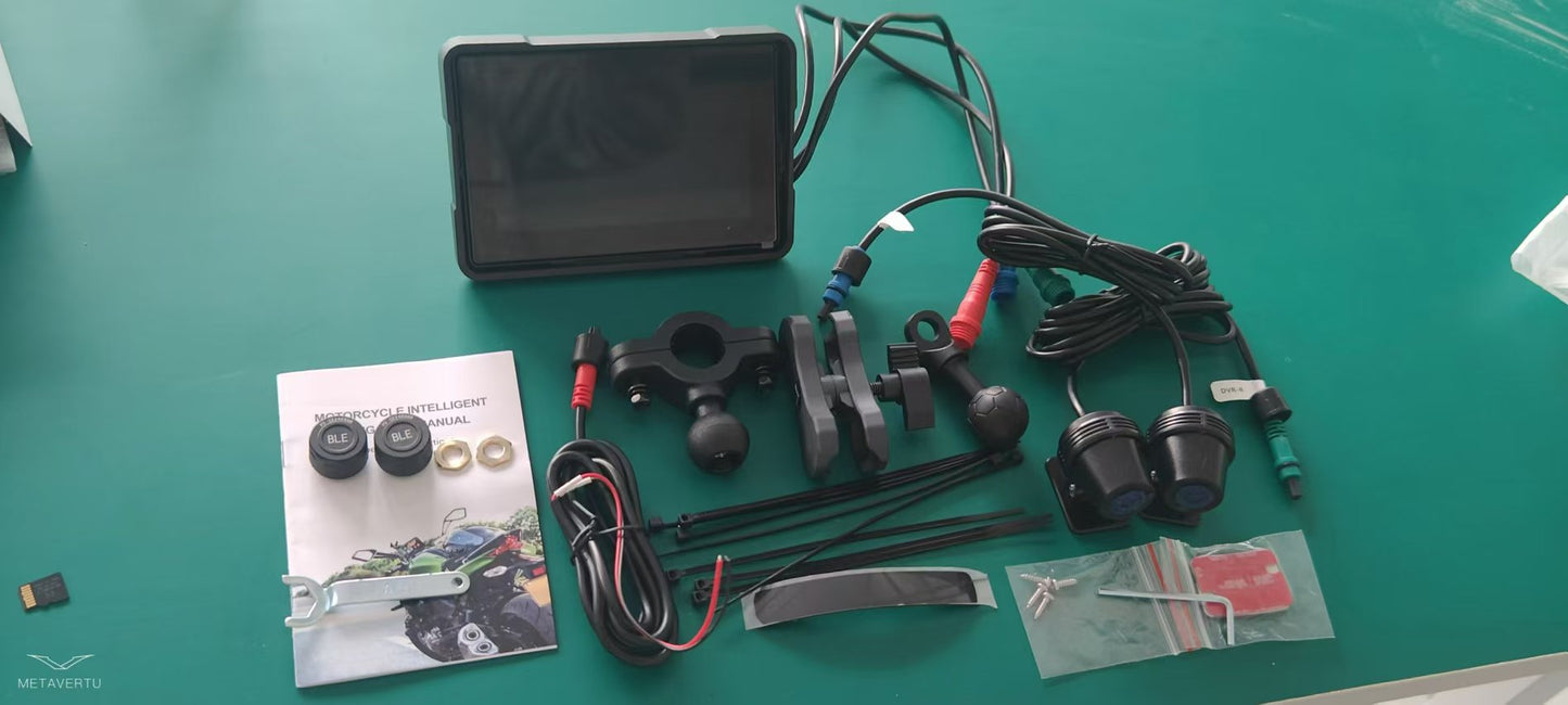 Motorcycle wireless navigation device components including screen, cables, mounts, and user manual on green surface.