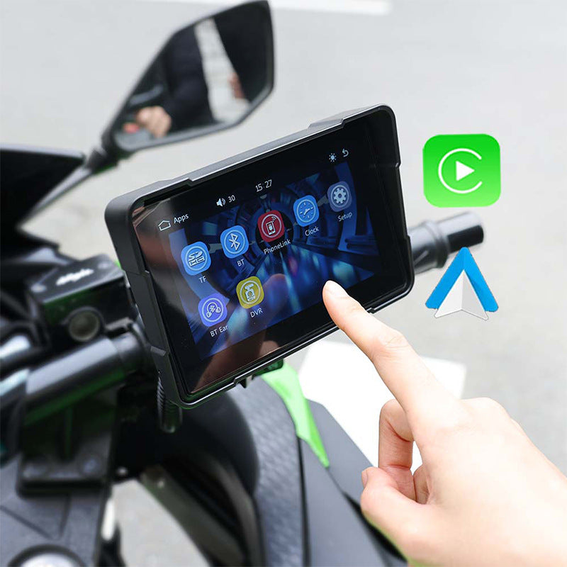 Motorcycle wireless navigation device in use, showing touchscreen with navigation apps and controls on bike handlebar.