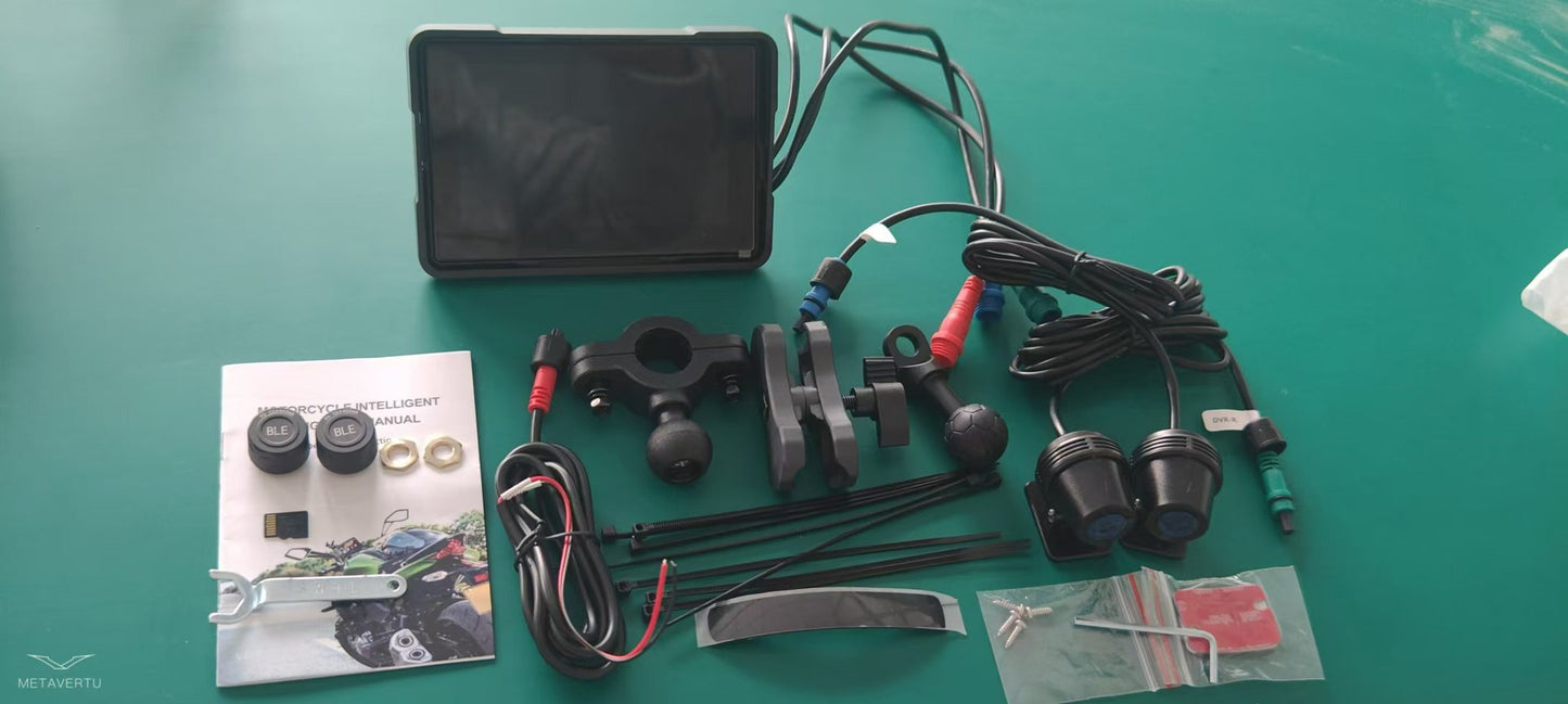 Motorcycle wireless navigation device components including screen, cables, mounts, and user manual on green surface.